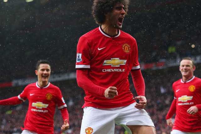 Marouane Fellaini celebrates after scoring United’s second goal with a powerful header in their 4-2 win over City in the Manchester derby at Old Trafford