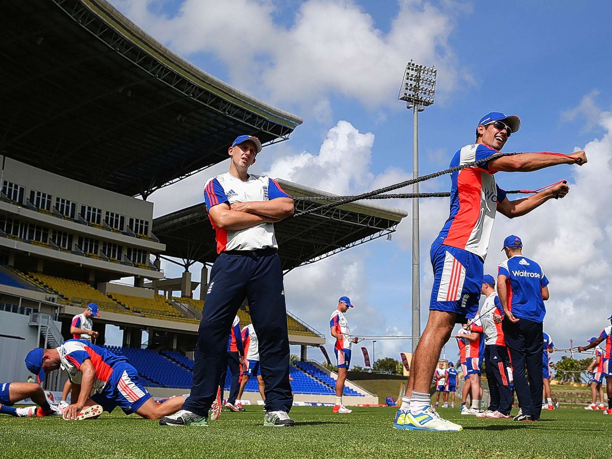 Captain Alastair Cook (right) stretches during the England nets session in Antigua on Saturday