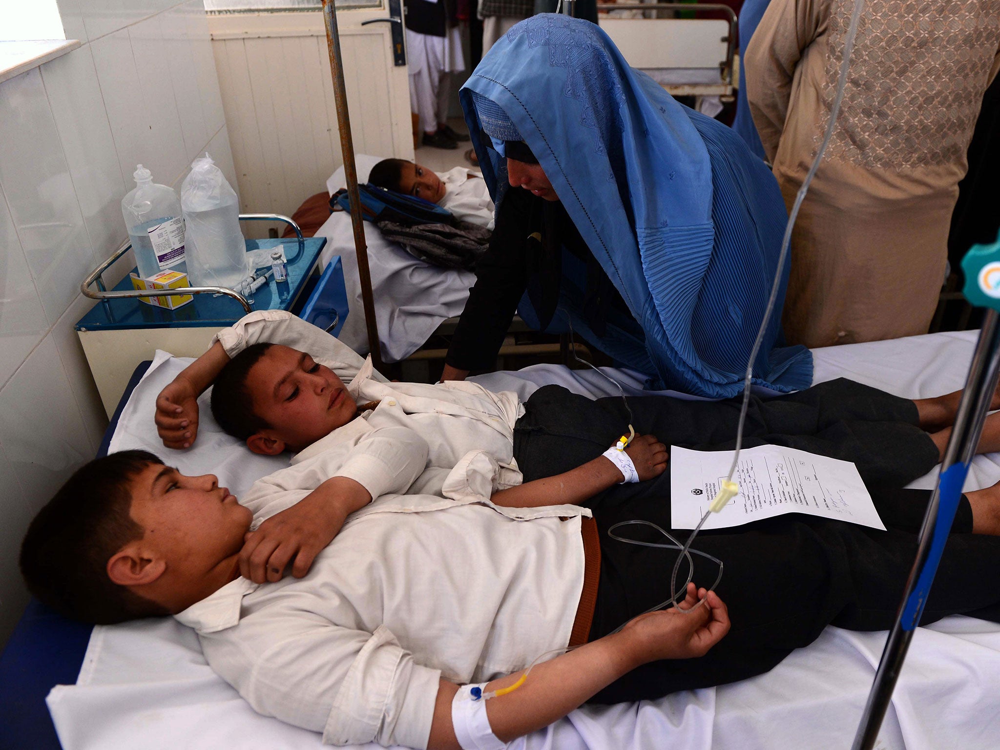 Schoolchildren lie in bed as they are treated for poisoning at Afghan hospital
