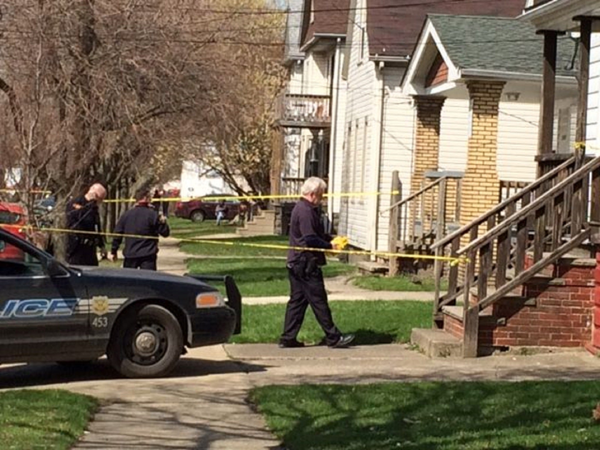 Authorities investigate the scene after a shooting involving two children on Sunday April 12, 2015