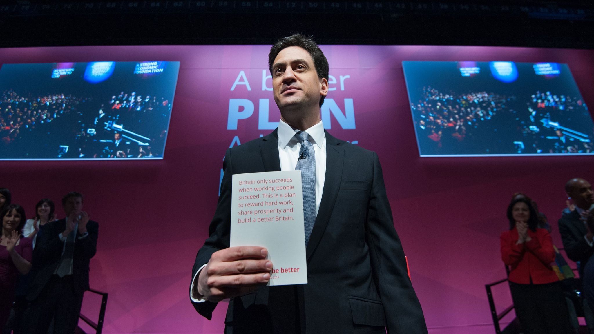Ed Miliband poses with Labour's 2015 manifesto