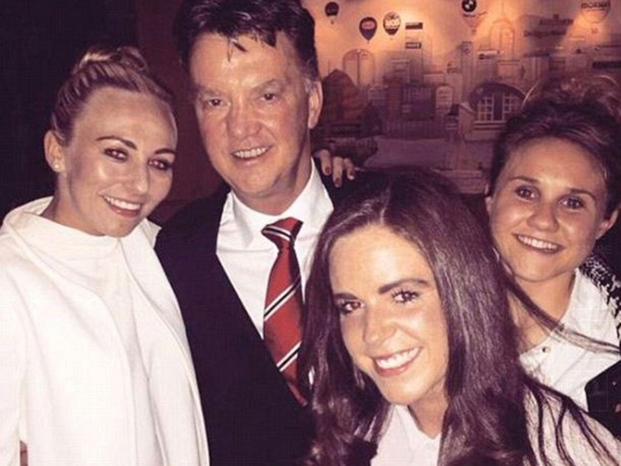 Louis van Gaal with Manchester City women's players Toni Duggan (left) and Isobel Christiansen (right). Plus Everton player Michelle Hinnigan (front)