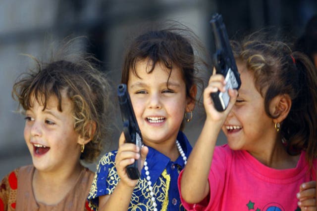 Iraqi Shiite children  from Mosul play with toy guns
