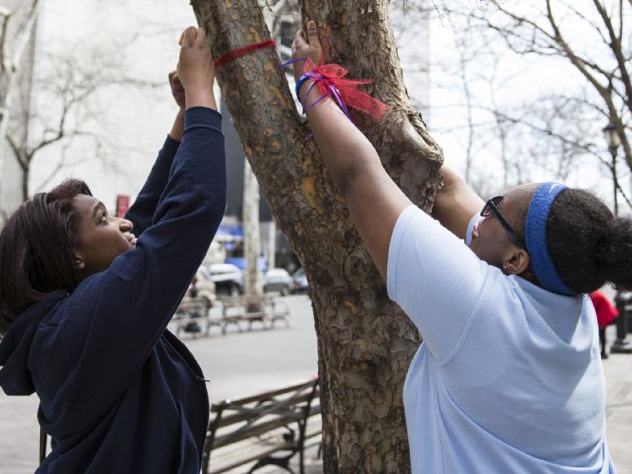 US schoolgirls commemorate the kidnapping of hundreds of Nigerian school girls by Boko Haram during a rally bringing attention to the one year anniversary, in New York