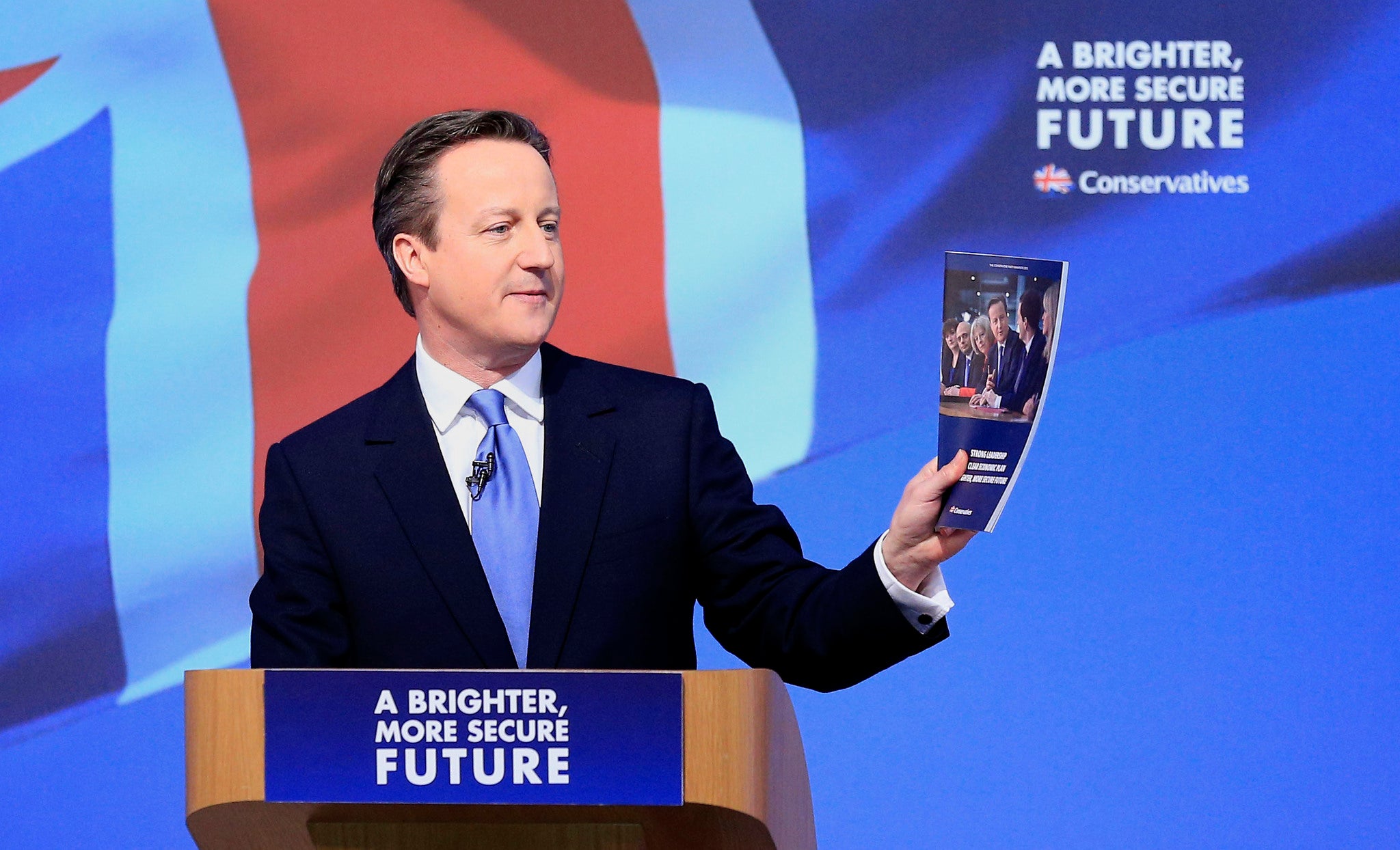 David Cameron shows off the Conservative party's manifesto (PA)