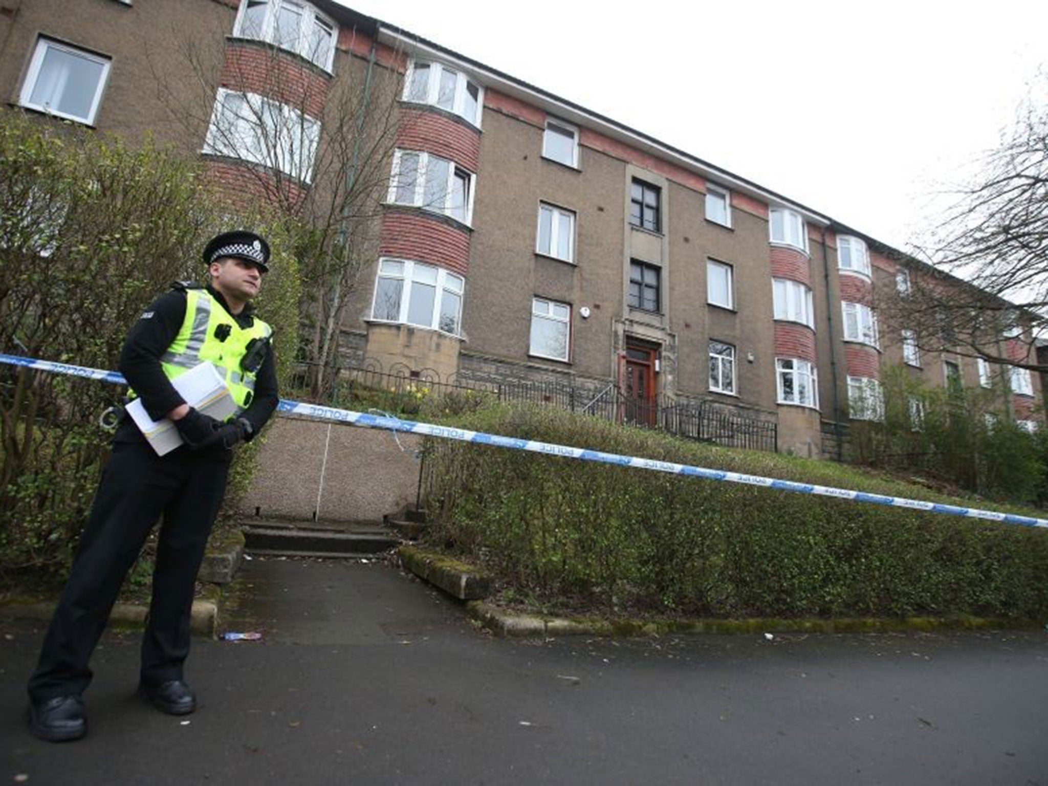 Police outside flats in Dorchester Avenue in Glasgow during the investigation