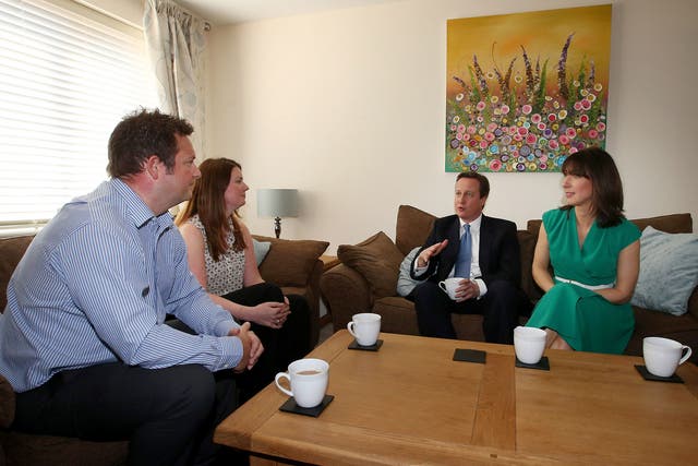 Prime Minister David Cameron and his wife Samantha meet Nicole Calver and Paul Pearson in their home in Swindon. The Conservatives have launched their election manifesto with a promise to extend the right to buy housing scheme for housing association tena