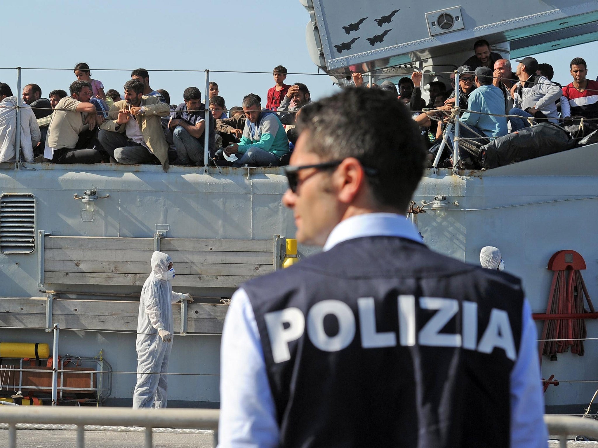 An Italian military ship with would be immigrants onboard in the port of Pozzallo, Sicily, last year