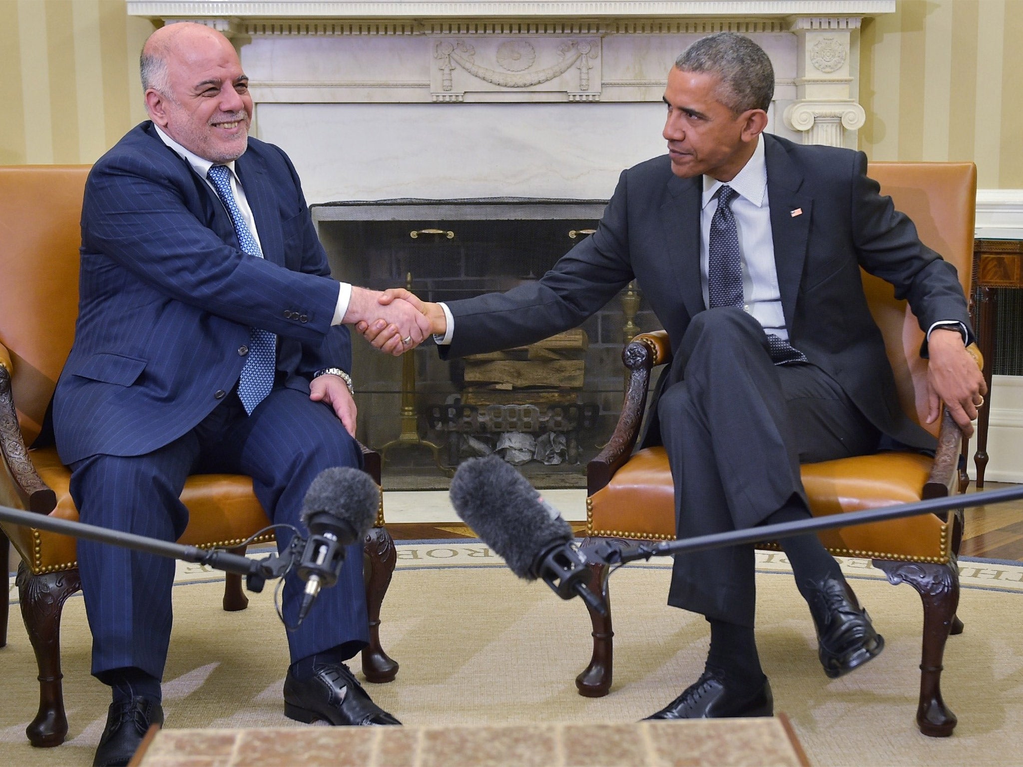 Barack Obama shakes hands with Haider al-Abadi on Tuesday