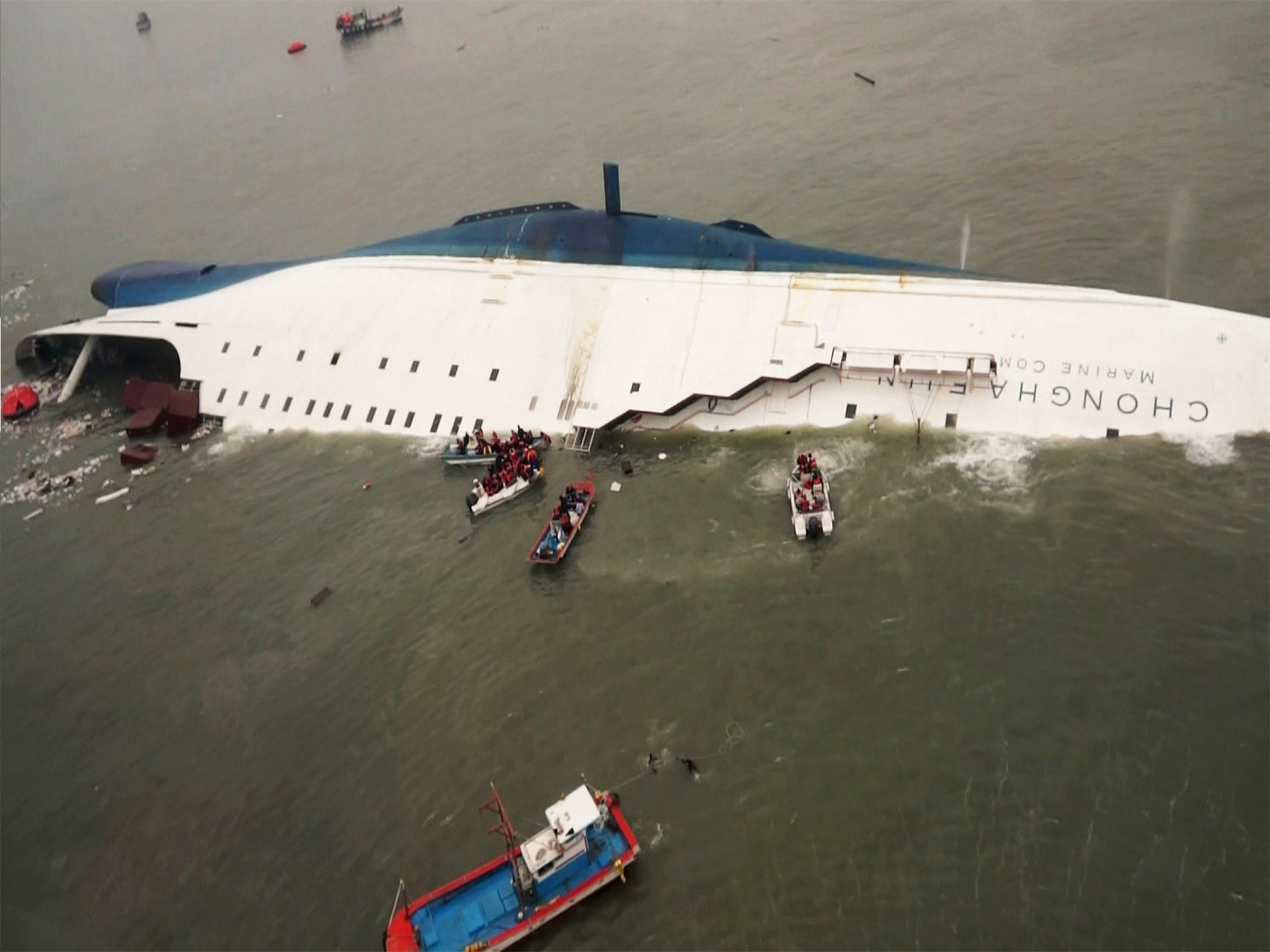 Rescue boats approach the sinking ‘Sewol’ in waters off South Korea’s southern coast last April; 304 people drowned