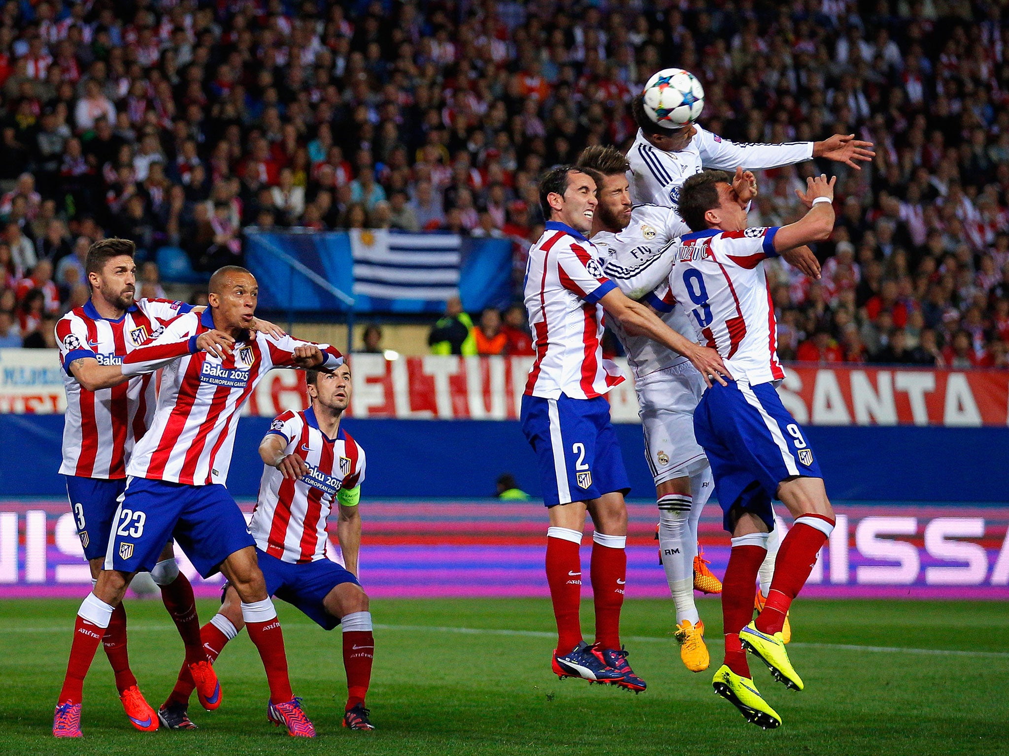 Raphael Varane heads the ball during the the Madrid derby