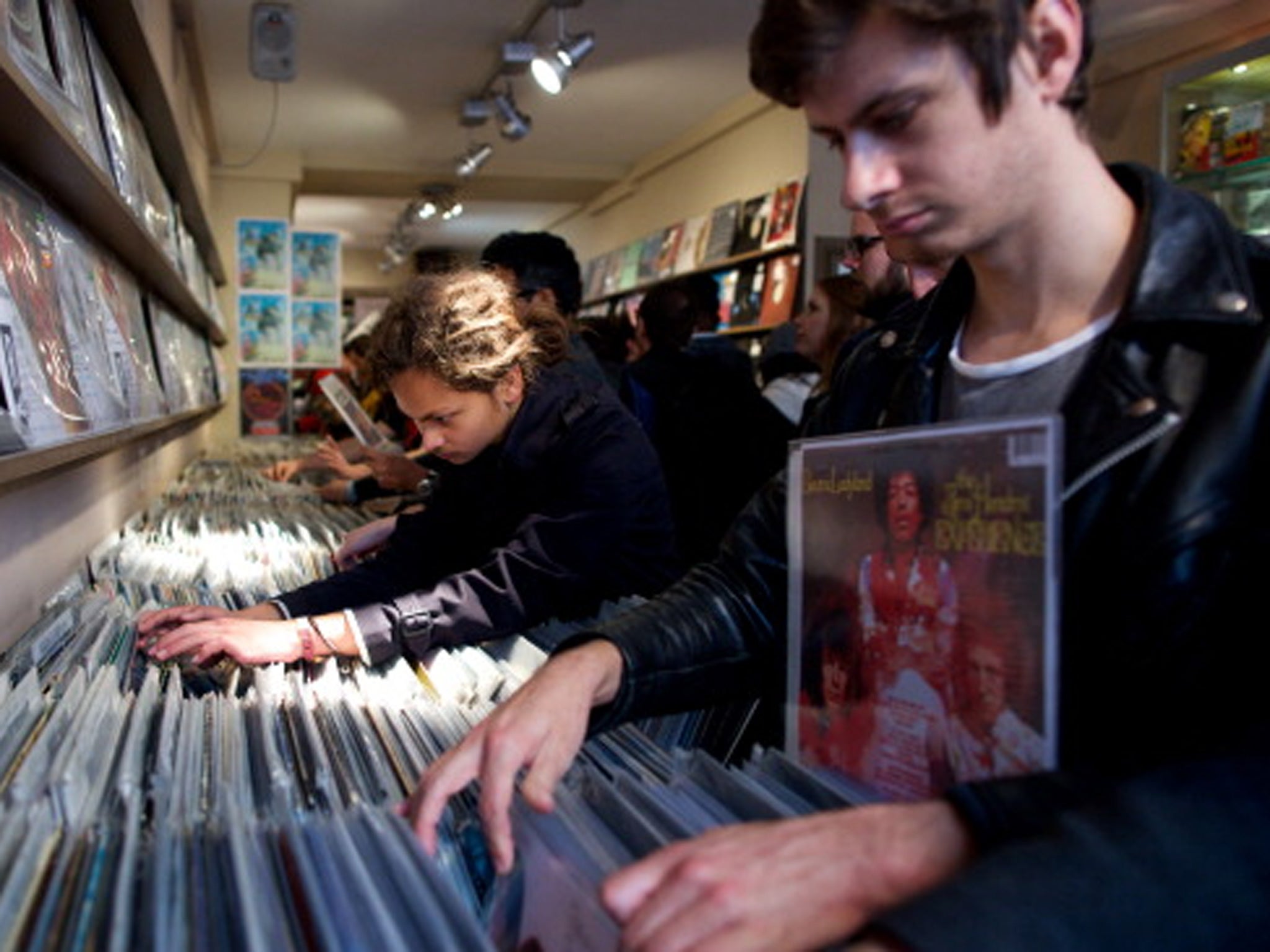 People look through vinyl records in a shop on Record Store Day 2014 in central London