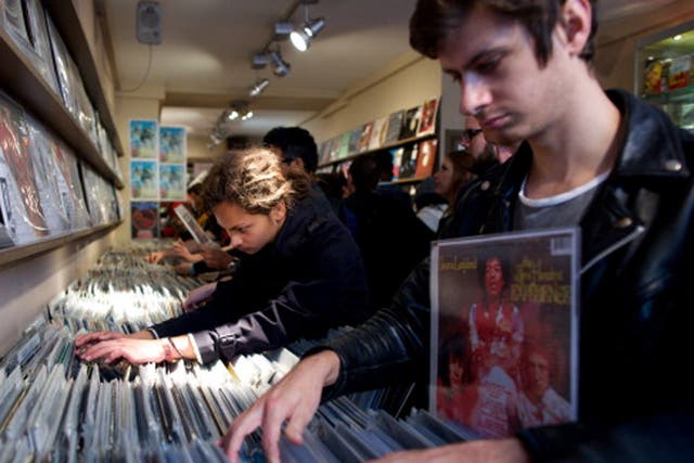 People look through vinyl records in a shop on Record Store Day 2014 in central London