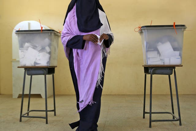 A Sudanese woman prepares to cast her vote at a polling station in Khartoum; one district of the capital had a 3 per cent turnout of registered voters 