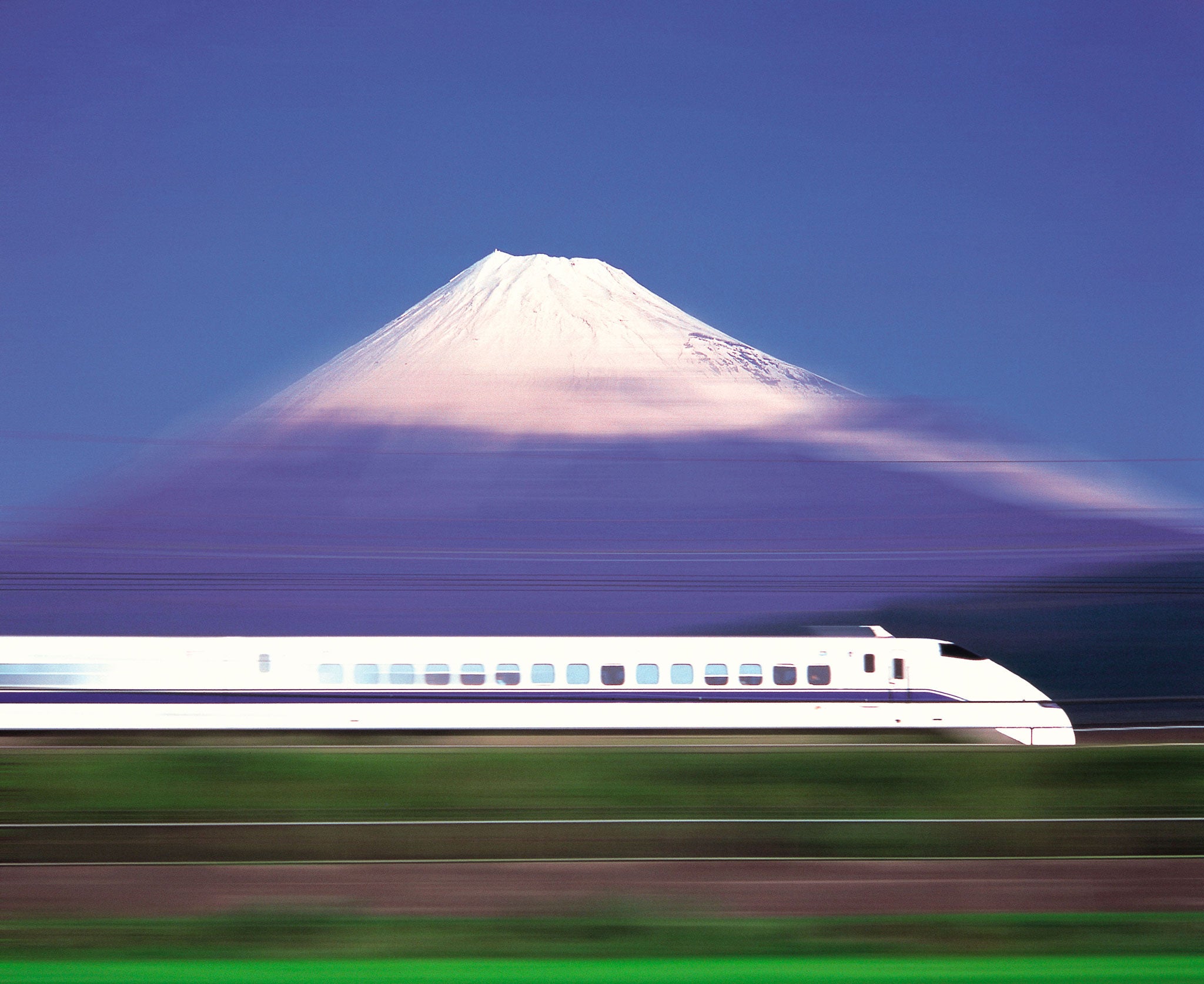 Box-fresh at 200mph: A bullet train races past Mount Fuji