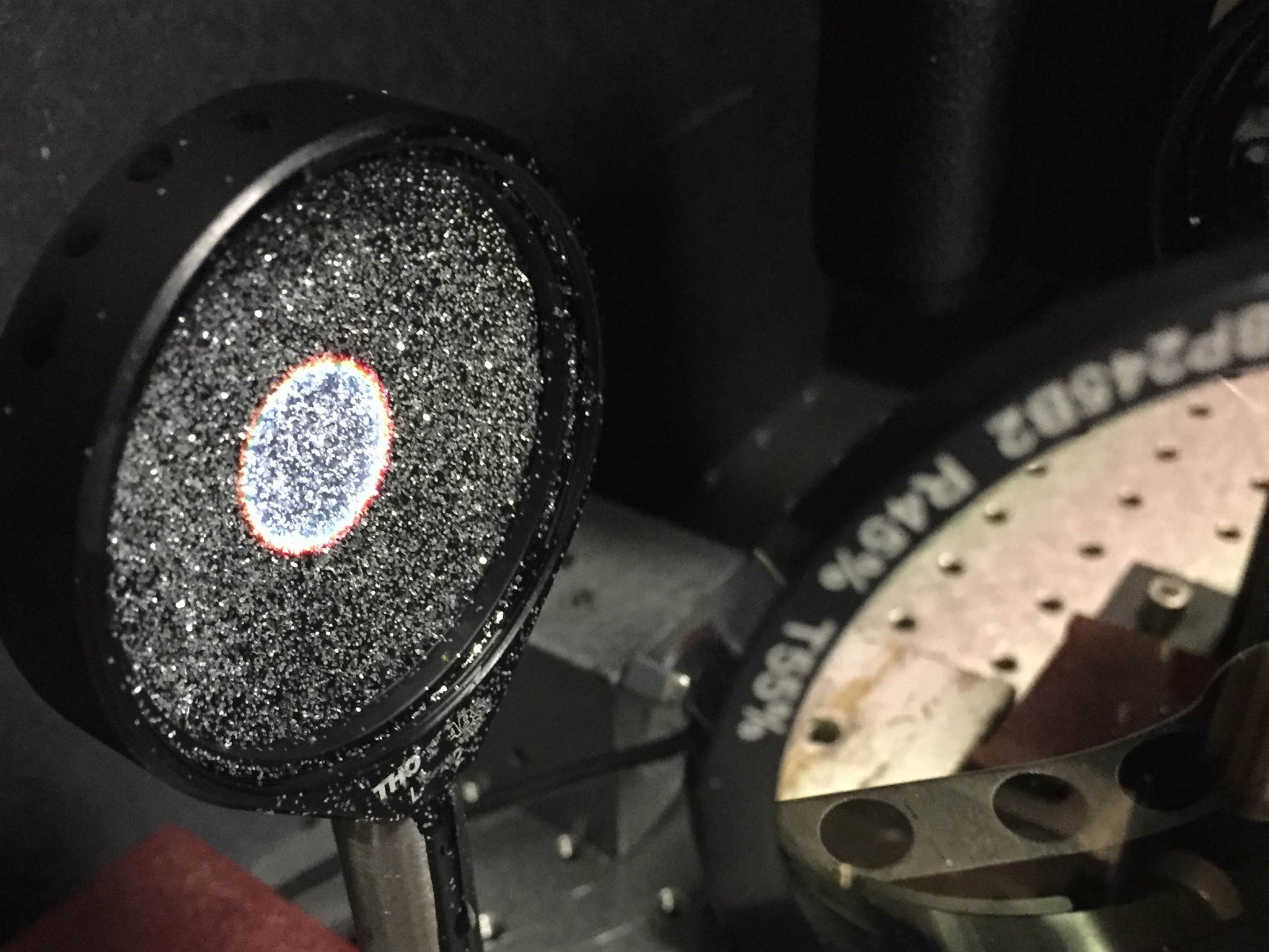 Researchers made a mirror surface out of glitter to test the idea of using a cloud of reflective particles as a space telescope mirror. They took images of two light sources using this mirror in a laboratory at Rochester Institute of Technology