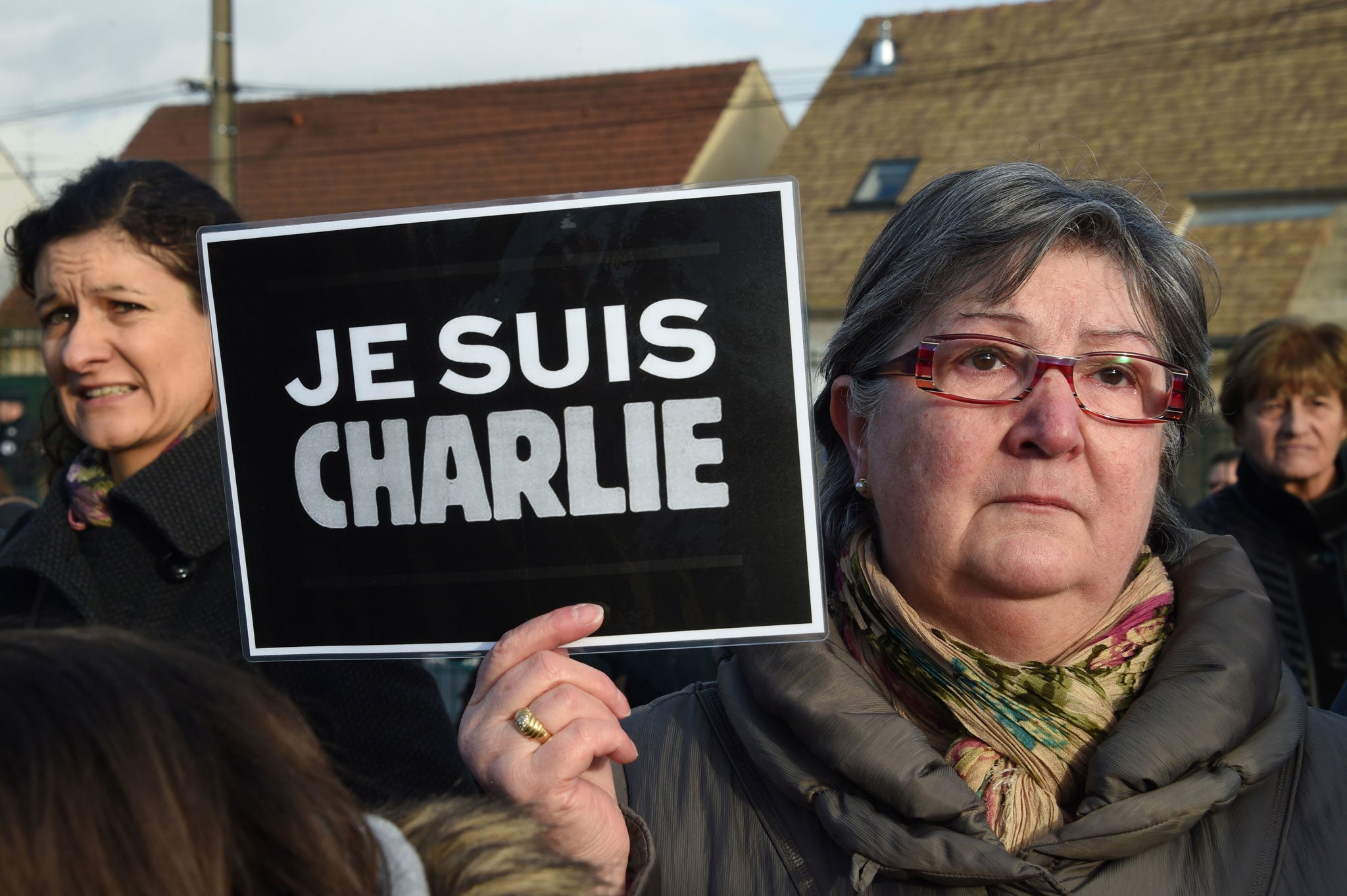 A woman holds a placard reading 'Je suis Charlie' as she attends the funeral of French cartoonist and Charlie Hebdo editor Stephane 'Charb' Charbonnier, on 16 January 2015 in Pontoise, outside Paris.
