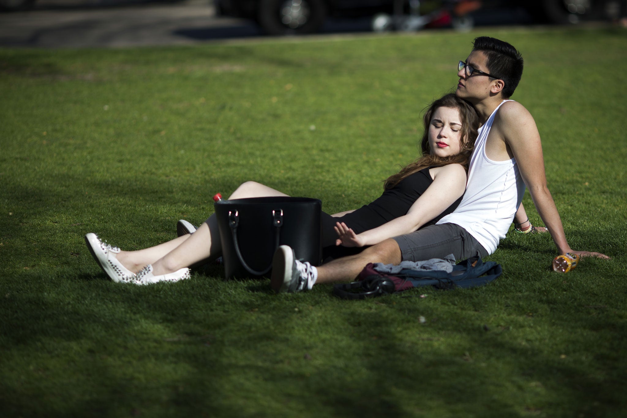 A couple relax in the sunshine in St James Park on 14 April 2015 in London. Today has been the hottest day of the year with temperatures reaching 24C in some parts of the country.