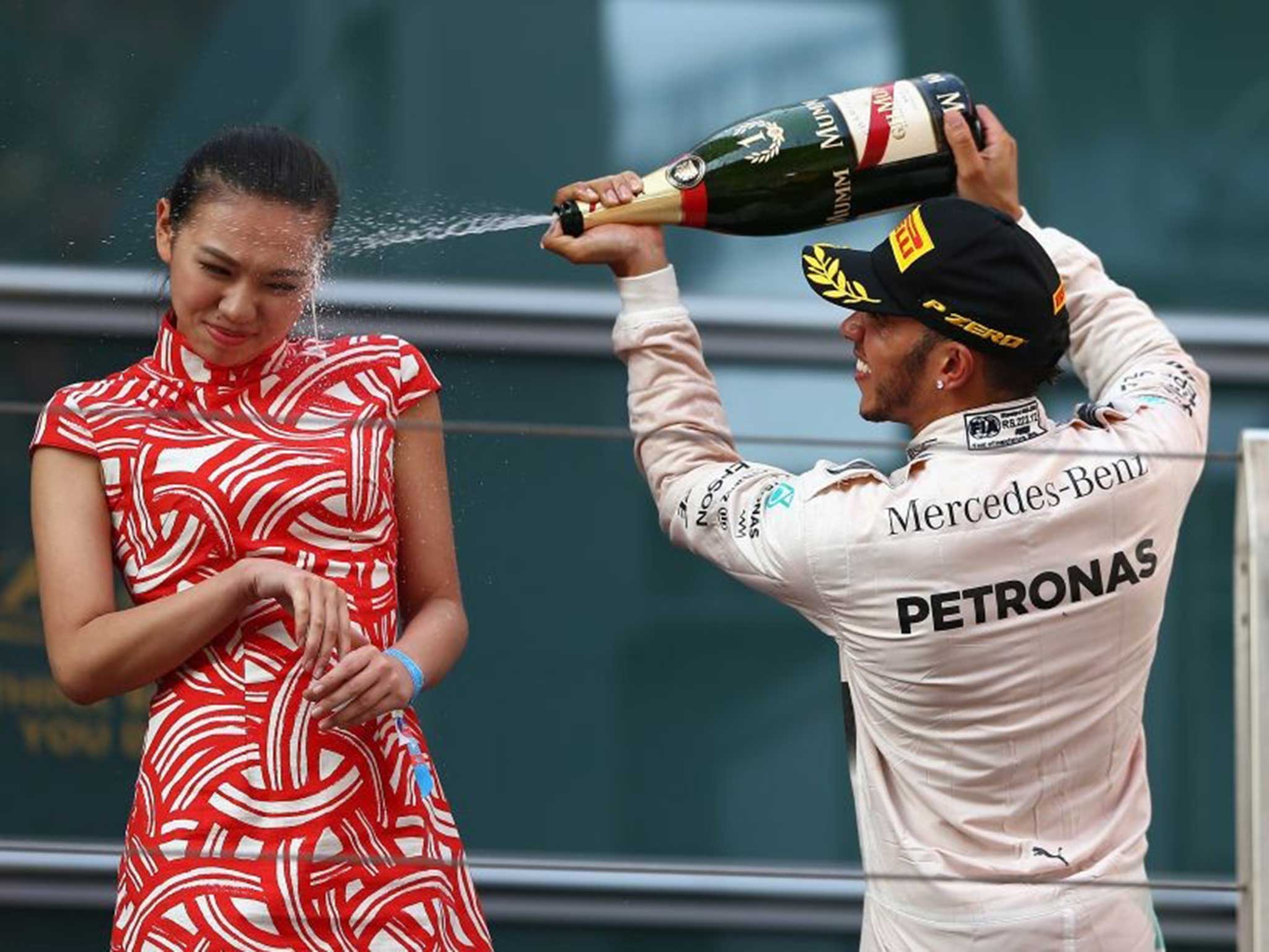 Lewis Hamilton sprays Champagne over Liu Siying after winning in China