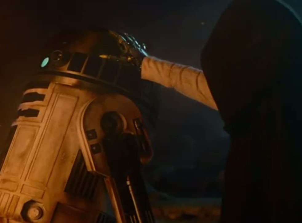 A mysterious hooded figure touches R2D2 in the latest trailer