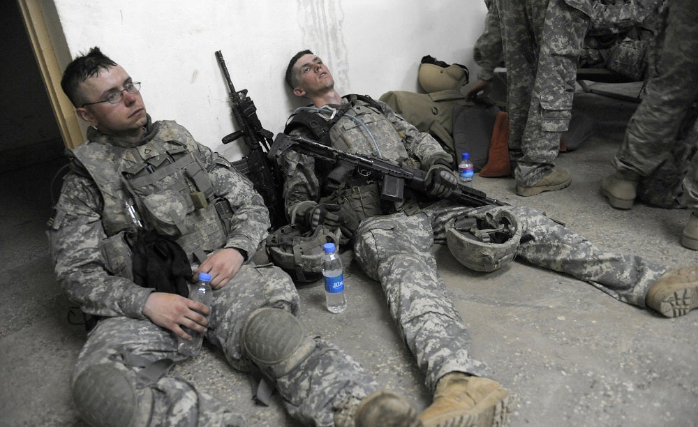 US soldiers from lie exhausted on the floor at an operation post after completing a mission to search for weapons caches in the Alaugal valley in Nishagam,Afghanistan in 2009.