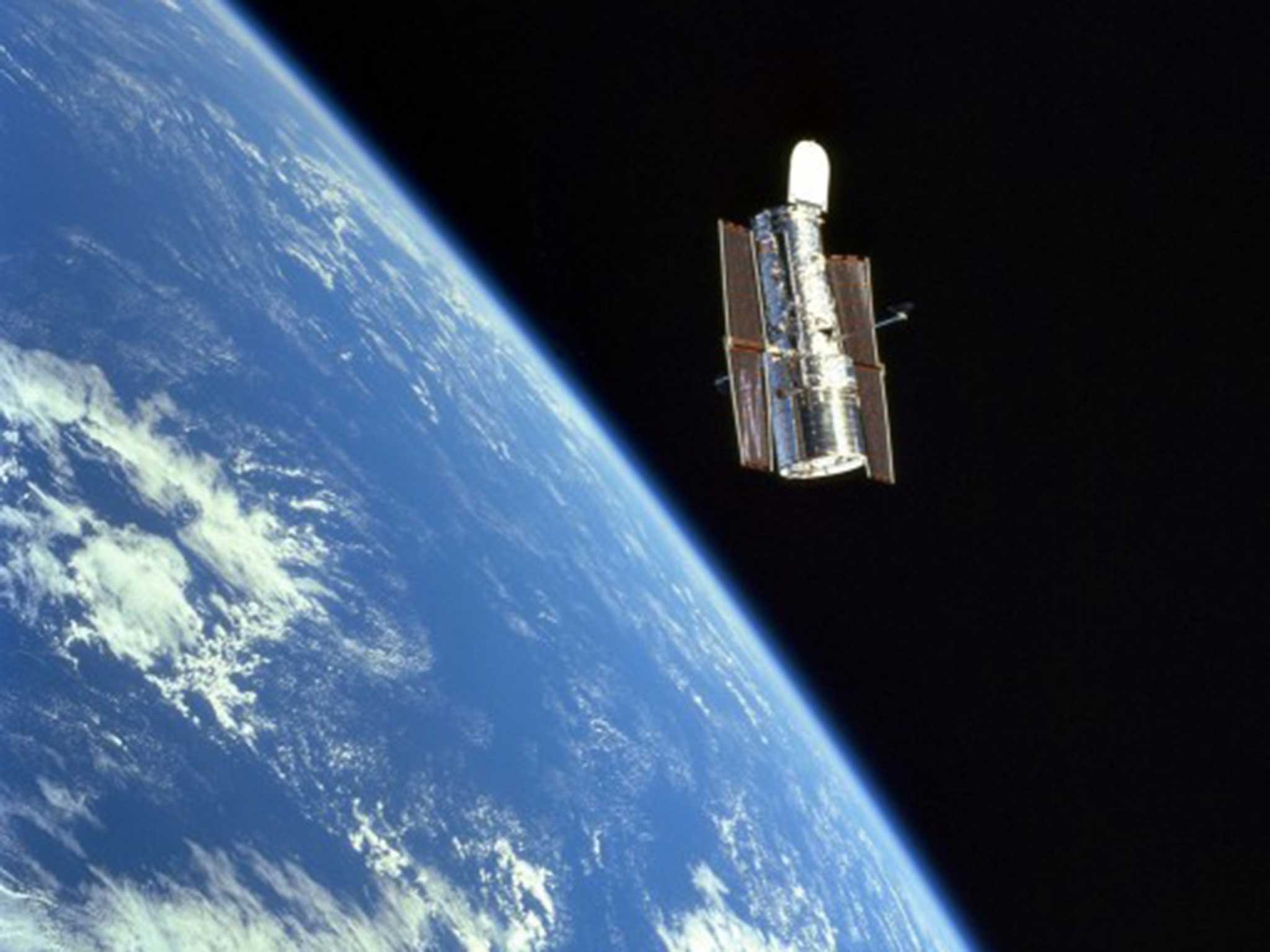 The Hubble telescope above the Earth after its first release in 1990