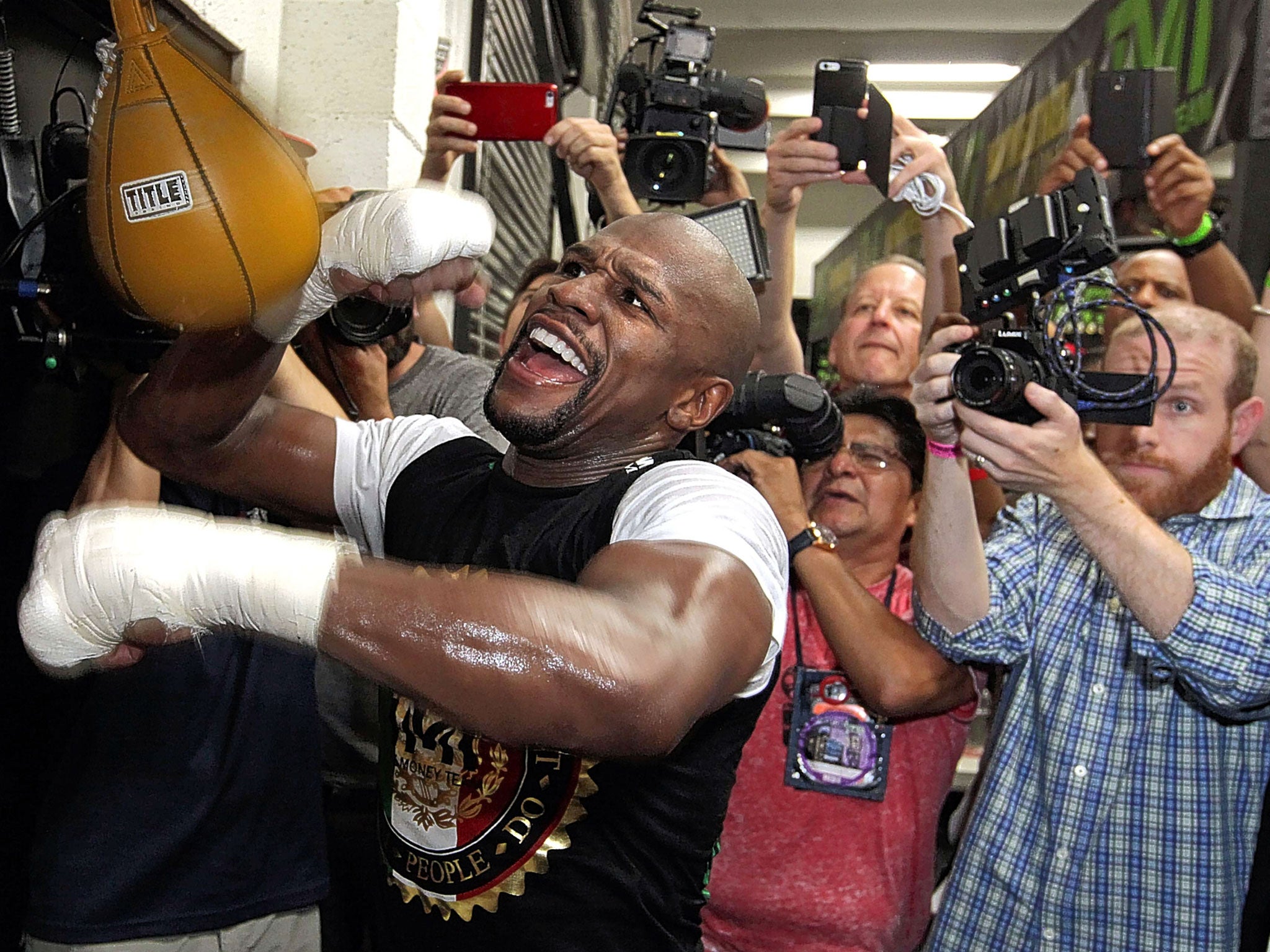 Floyd Mayweather hits the speed bag as he poses for photographers ahead of the big fight