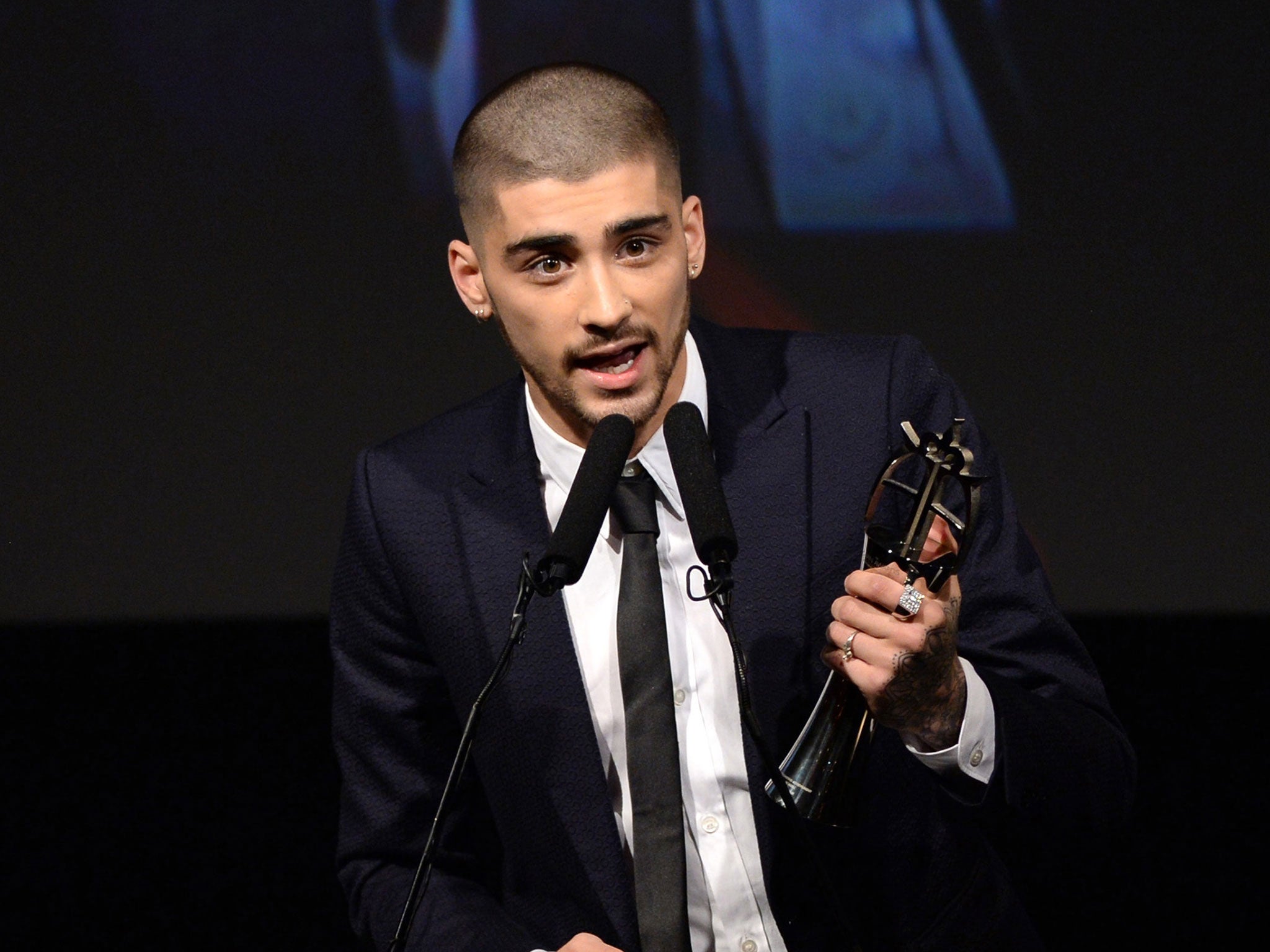 Former One Direction band member Zayn Malik receives his Outstanding Achievement in Music award at the 2015 British Asian Awards