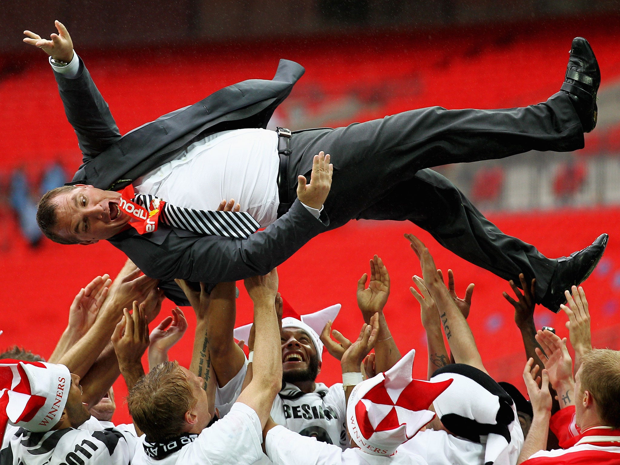 Brendan Rodgers celebrates the play-off final victory during his reign at Swansea
