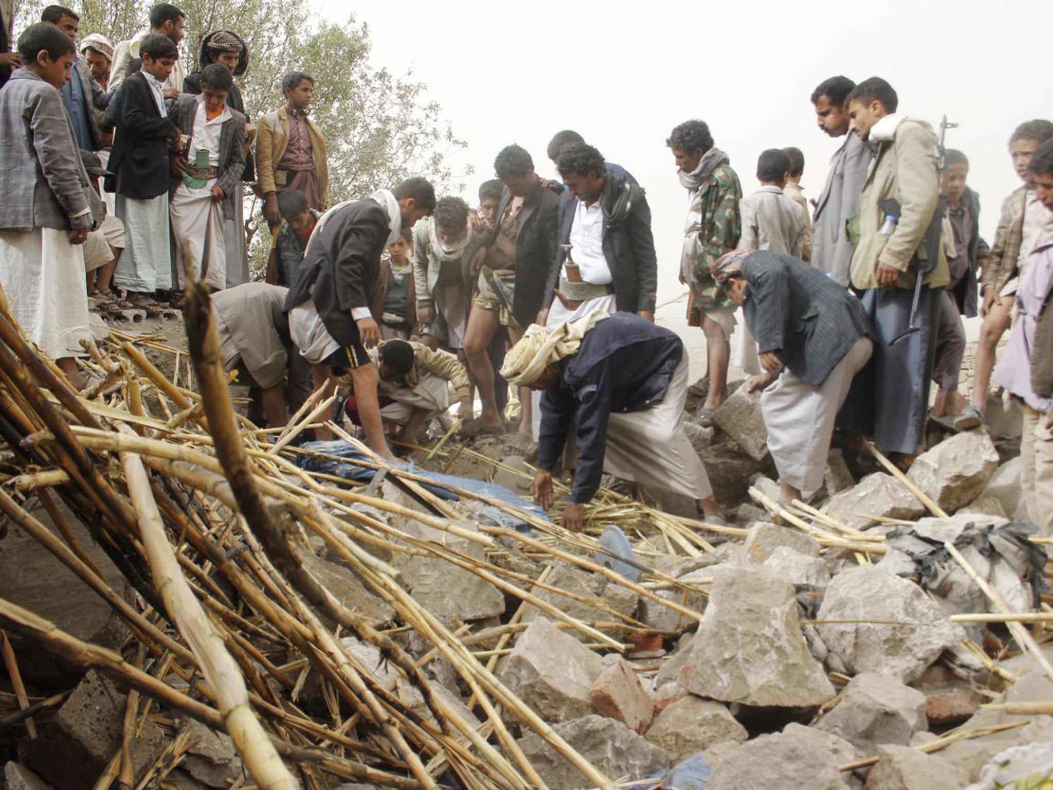 Yemenis search for survivors in the rubble of houses destroyed by Saudi-led airstrikes near Sanaa