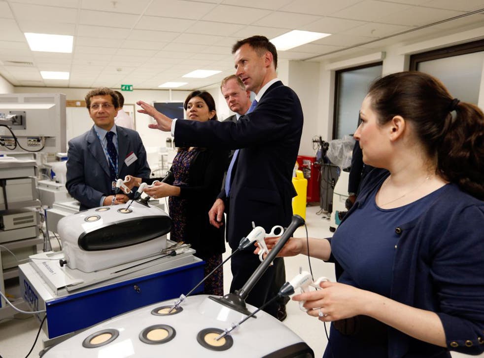 Jeremy Hunt, the Health Secretary, talks to medical staff prior to delivering a speech in 2013 on the ‘silent scandal’ of errors in the NHS