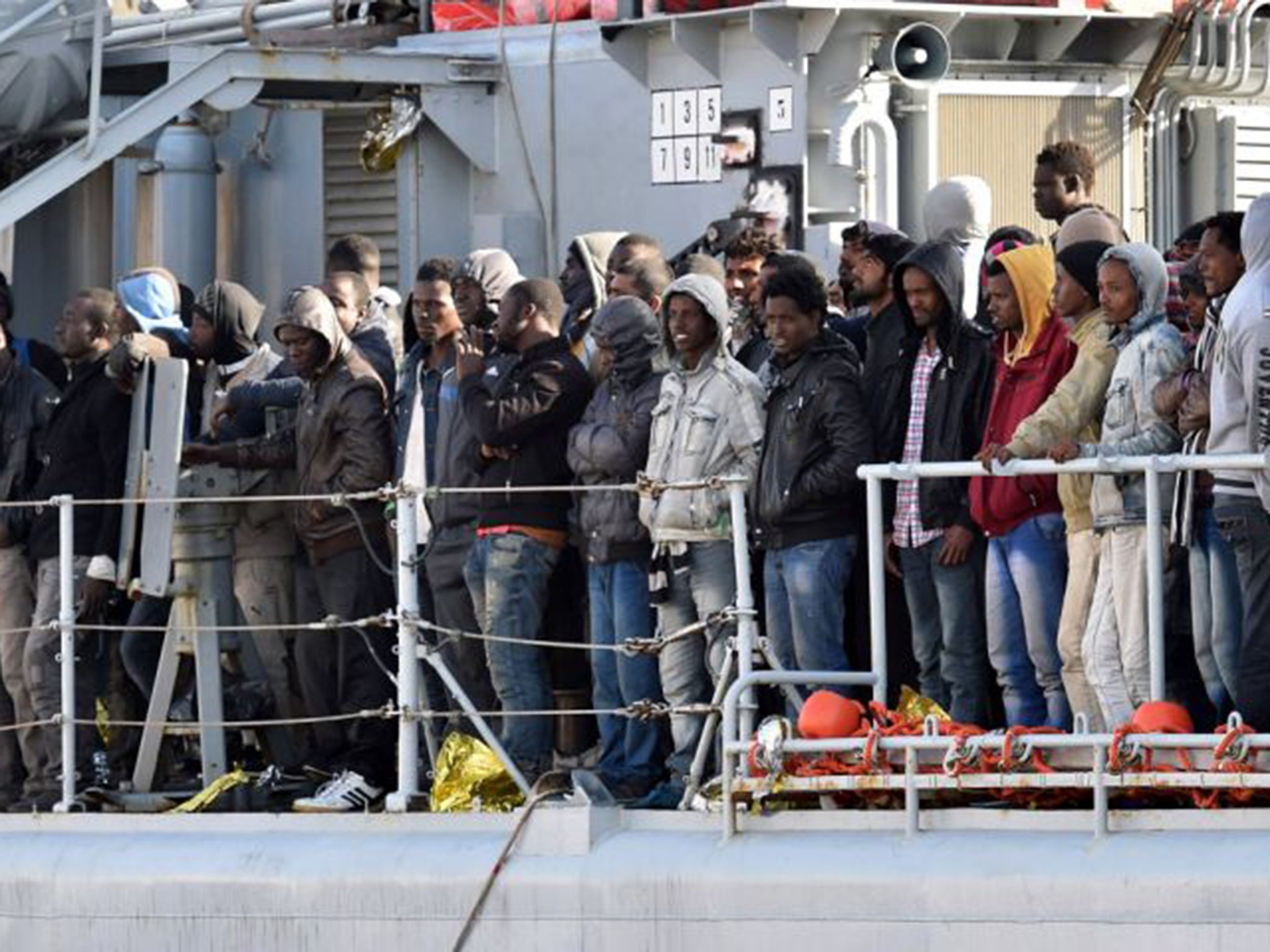 Migrants stand on the deck of the Italian Navy ship "Driade". Italian authorities have picked up some 10,000 people over the past week