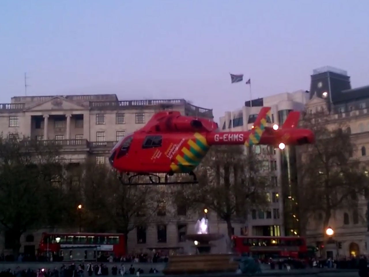 A London air-ambulance takes off from Trafalgar Square after helping treat the woman