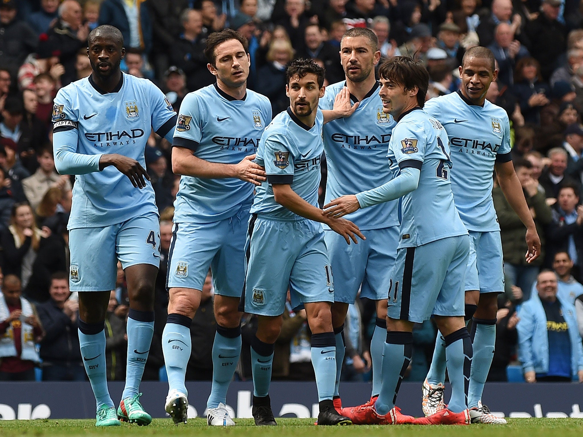Manchester City players celebrate going 1-0 up