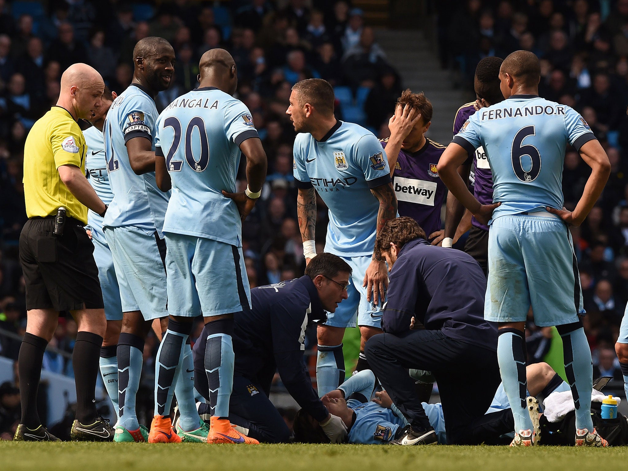 David Silva is treated after clashing with Cheikhou Kouyate