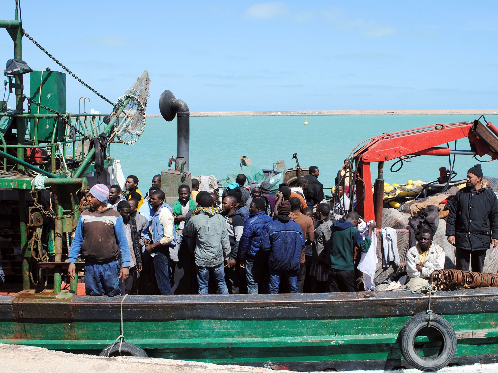 Illegal African migrants arrive at the port in the Tunisian town of Zarzis, some 50 kilometres west of the Libyan border after Tunisian fishermen rescued 82 African migrants off the coast of the town aboard a makeshift boat bound for the Italian island of