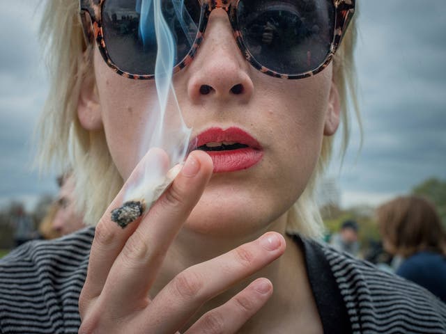 A woman marks '420 Day' in Hyde Park by smoking a spliff