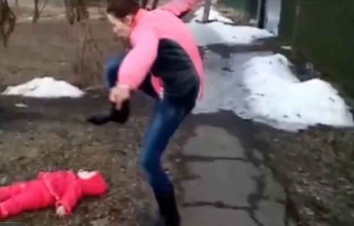 Russian woman throws baby to ground before pretending to 'stamp' on the