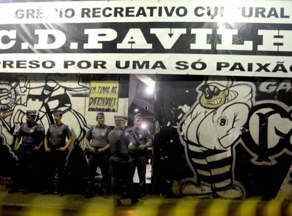 Police officers standing guard outside the headquarters of a fan group for the Corinthians  football club, Pavilhao Nove, in Sao Paulo