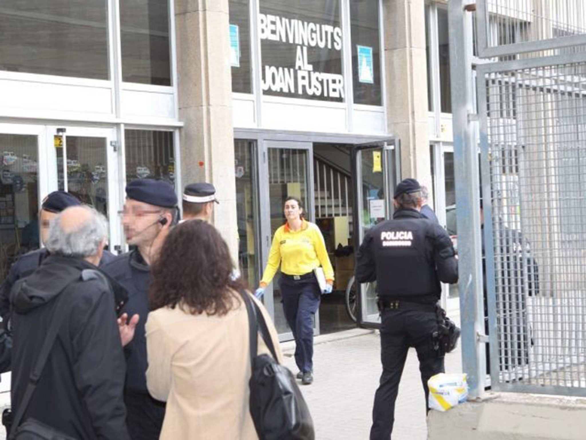 Police outside the Instituto Joan Fuster school after a student burst in with a knife and crossbow in Barcelona, 20 April 2015