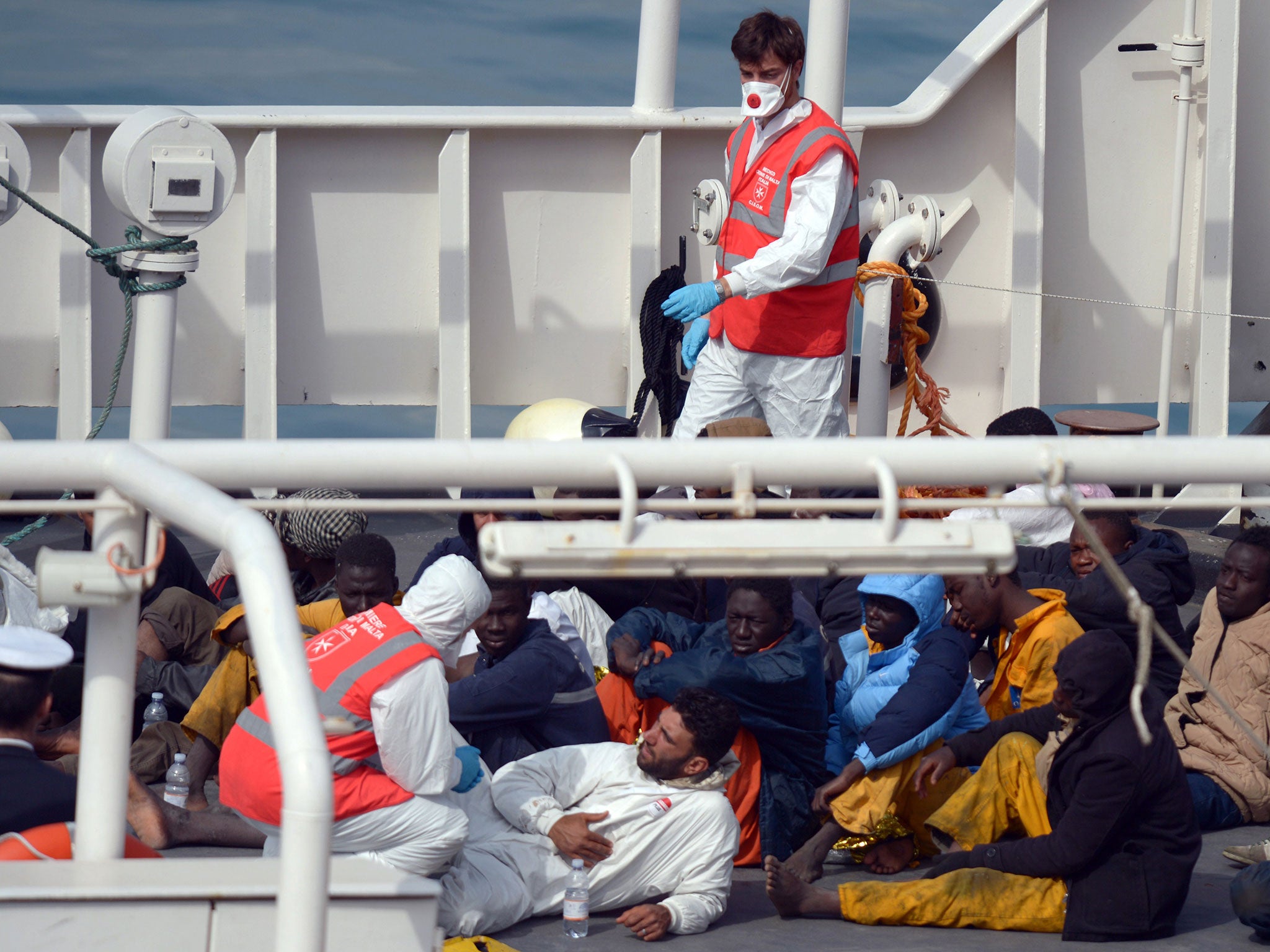 Rescued migrants talk to a member of the Malta Order (Matthew Mirabelli/AFP/Getty Images)