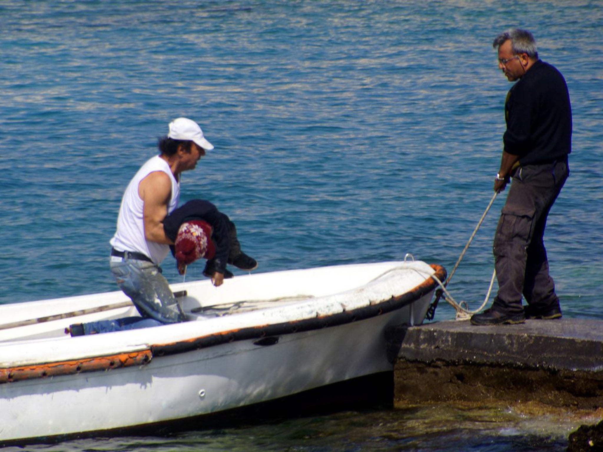 The body of a dead child is recovered off the coast of Rhodes. People smuggling is an industry where demand exceeds supply and the seller does not care greatly if the customer reaches their destination or not