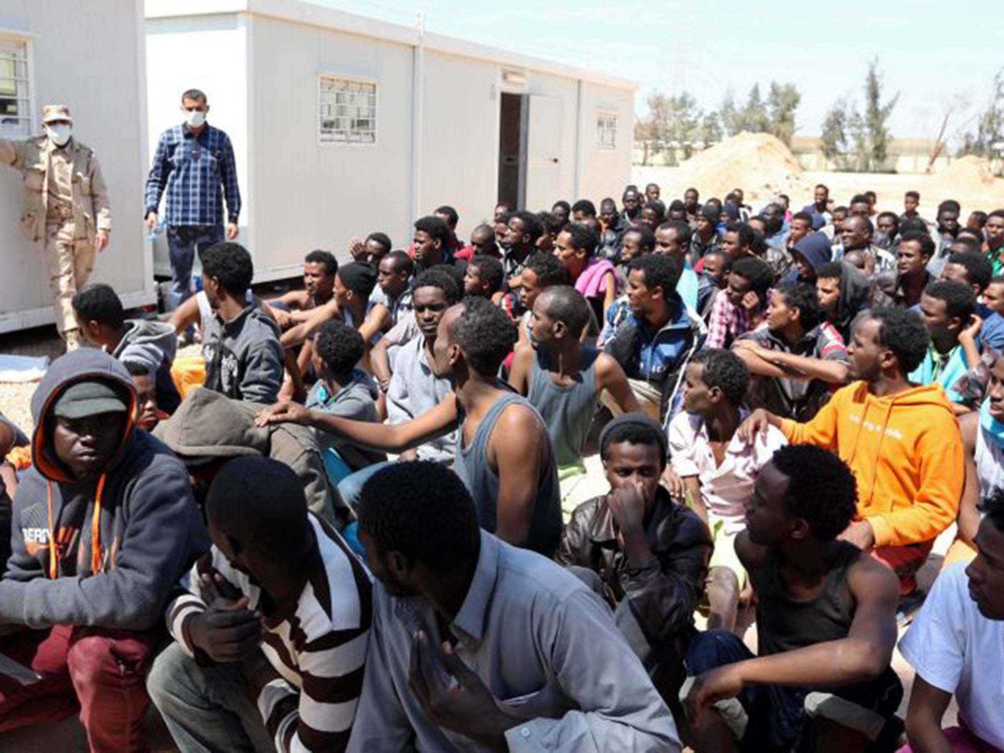 Migrants from sub-Saharan Africa sit at a centre for illegal migrants in Misrata on April 15 after their boat was intercepted by the Libyan coast guard