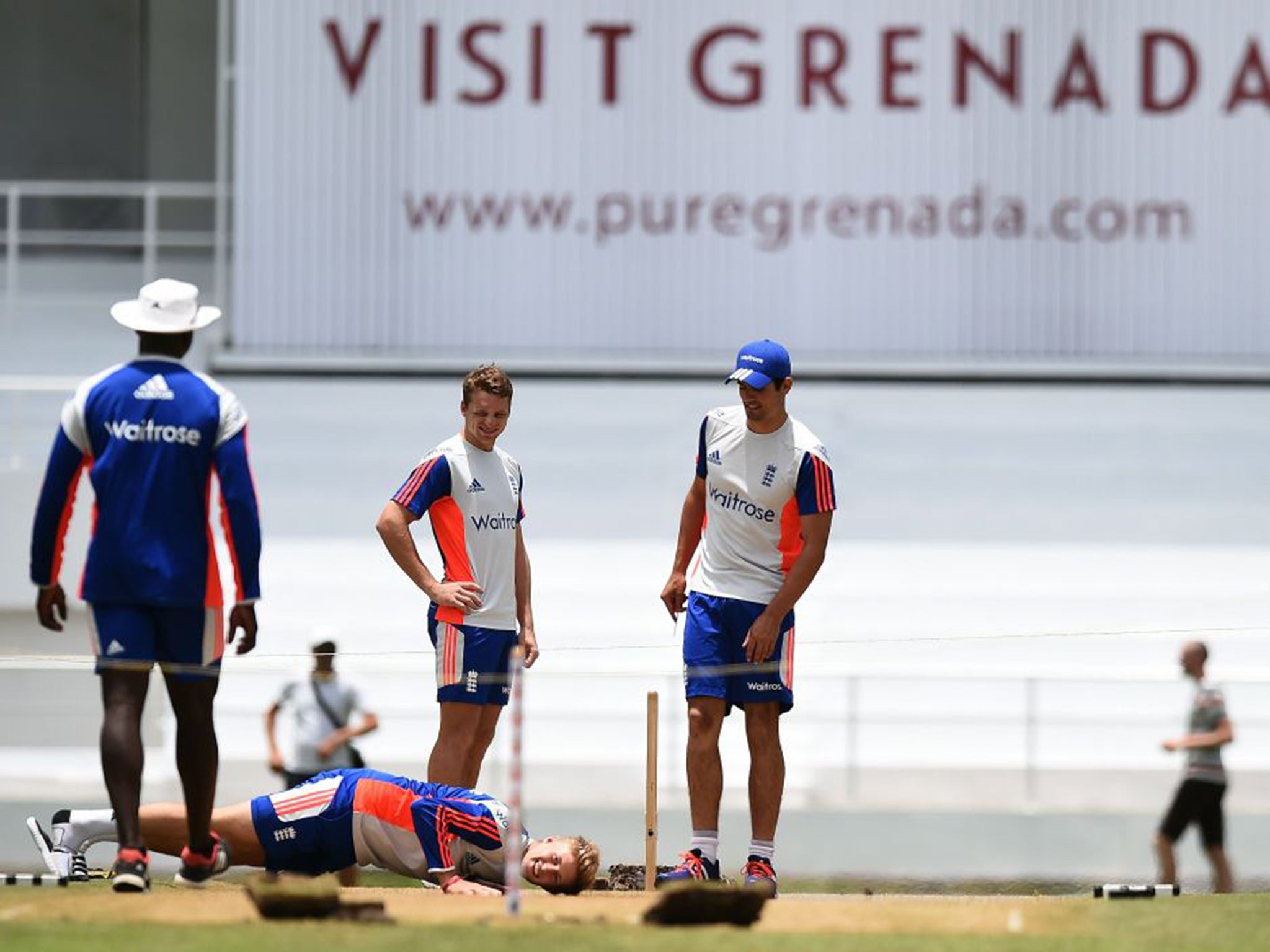 Joe Root takes a close look at the wicket and relays his findings to his under-pressure captain Alastair Cook, right, Jos Buttler, centre, and bowling coach Ottis Gibson