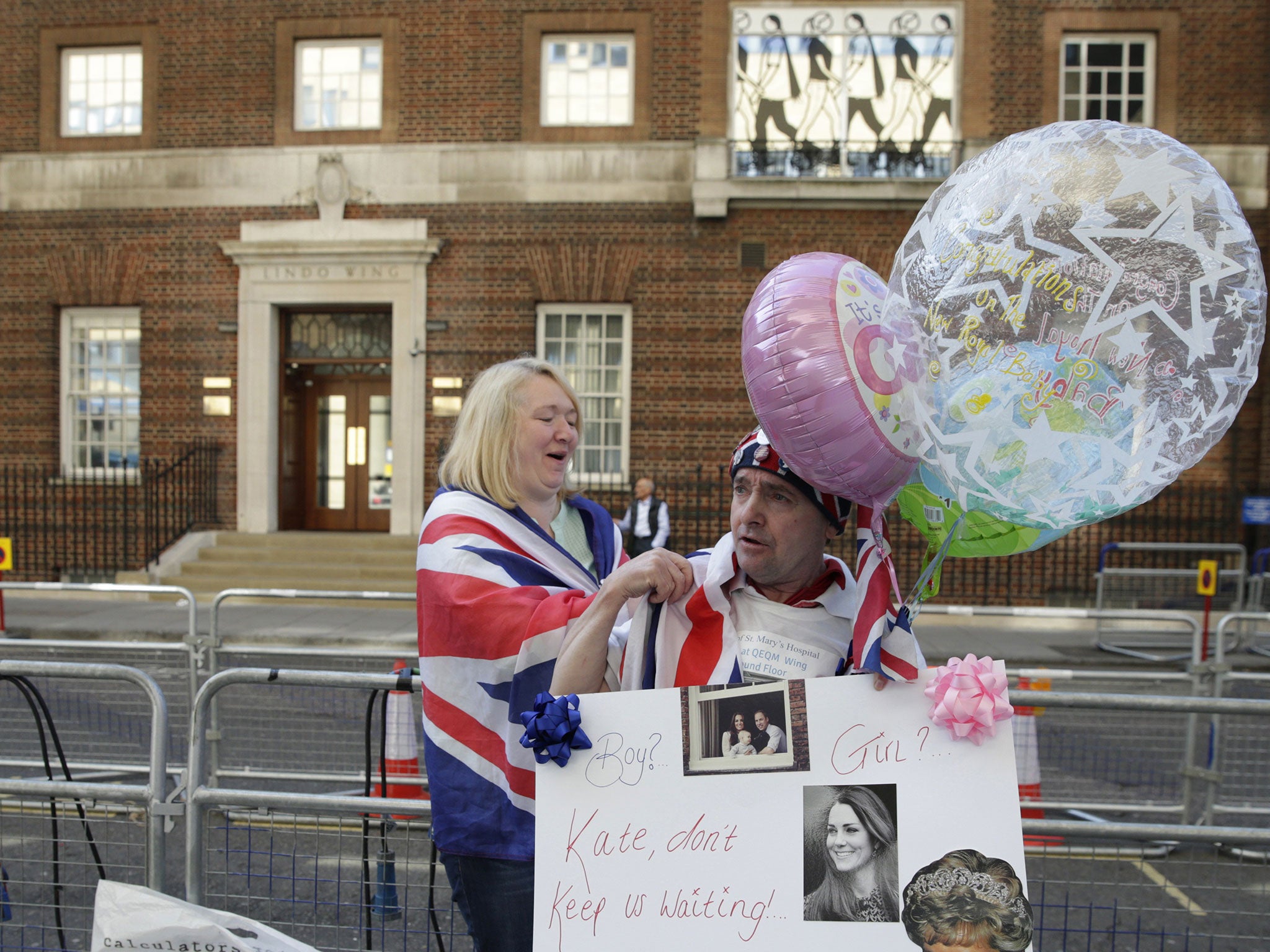 Royal fans Maria Scott and John Loughrey pose for a photograph outside the Lindo Wing at St Mary's Hospital in London, Monday, April 20, 2015