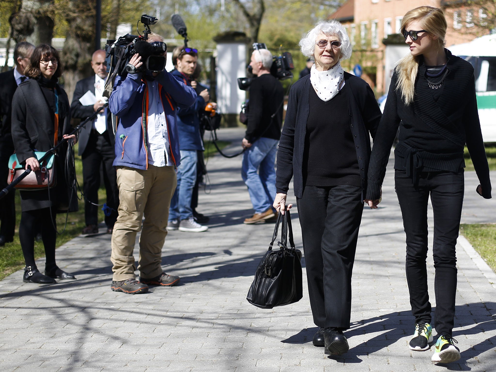 Auschwitz survivor Eva Pusztai-Fahidi, 2nd from right, from Budapest and her 23-years-old granddaughter Luca Hartai, right, leave the court hall during the noon breaks of the trial against former SS guard Oskar Groening