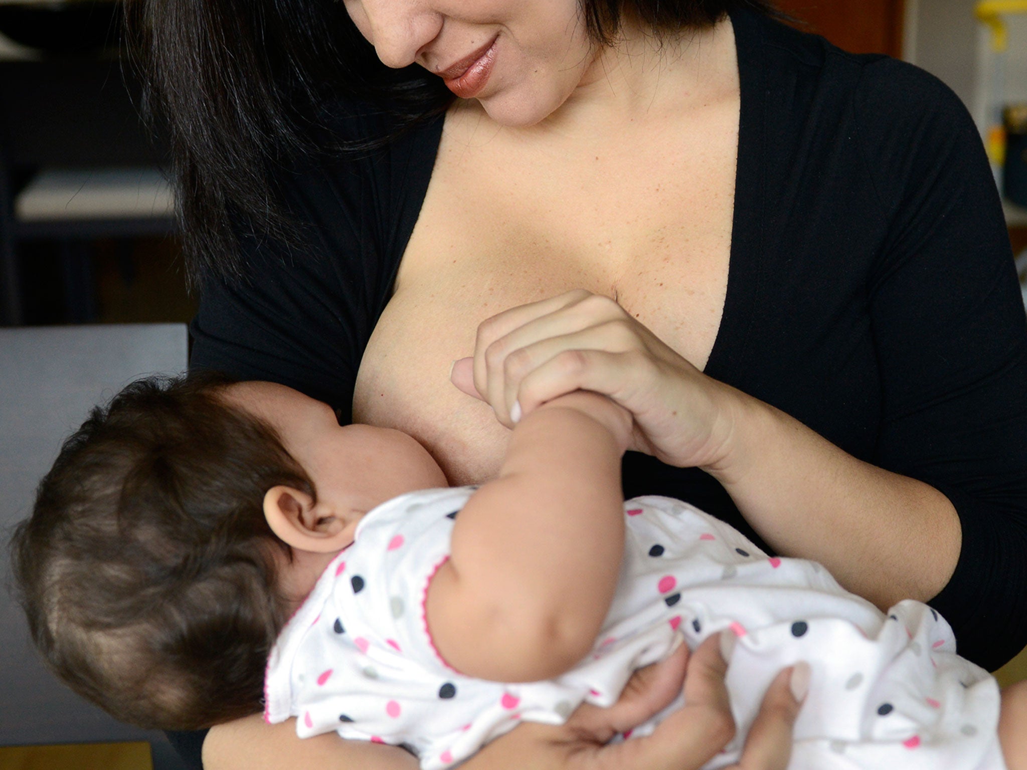 A woman feeds her child