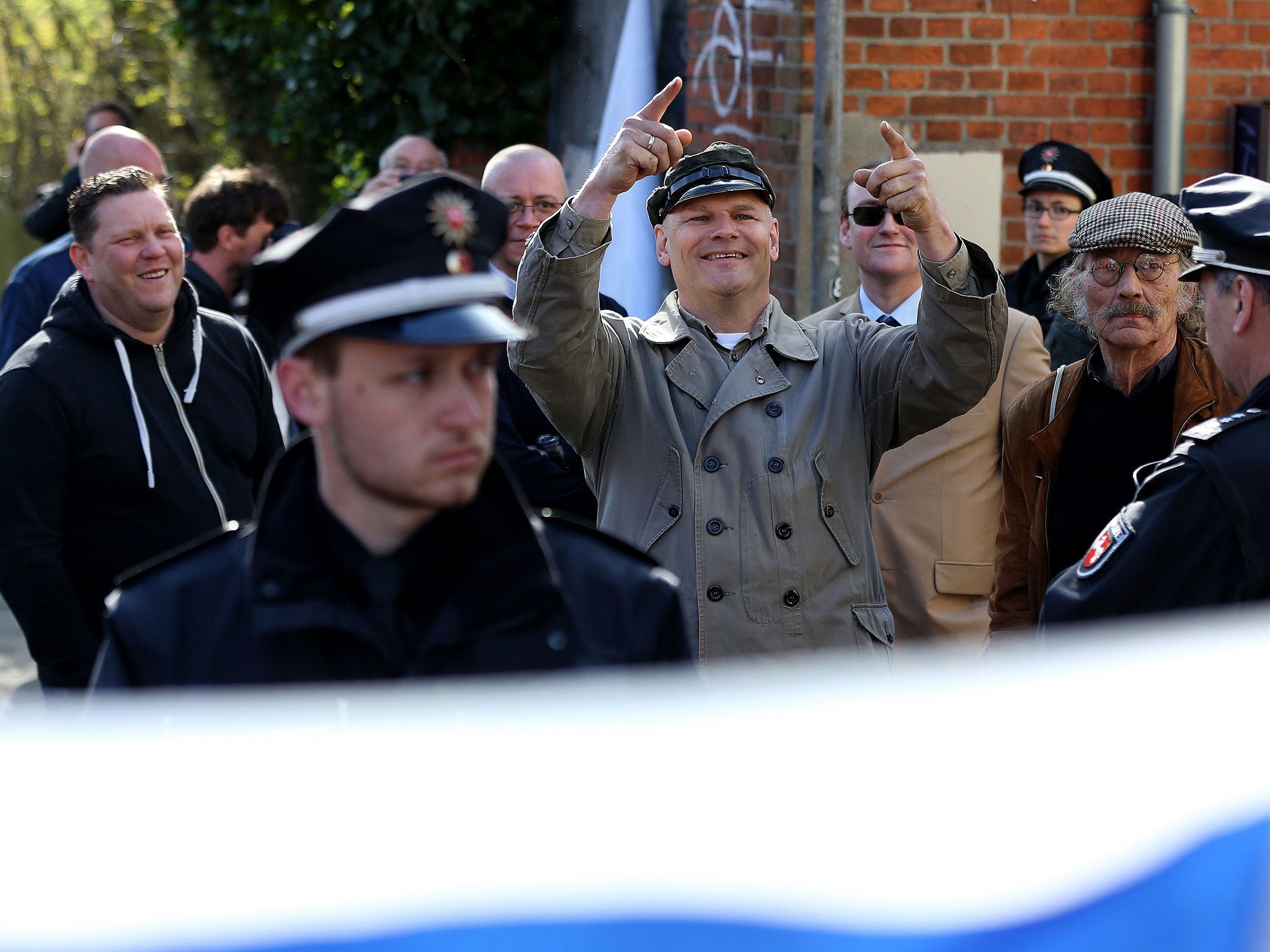 German neo-Nazi Thomas Wulff (C) stands in front of the venue of the trial against a former Nazi death camp officer on April 21, 2015 in Lueneburg, northern Germany.