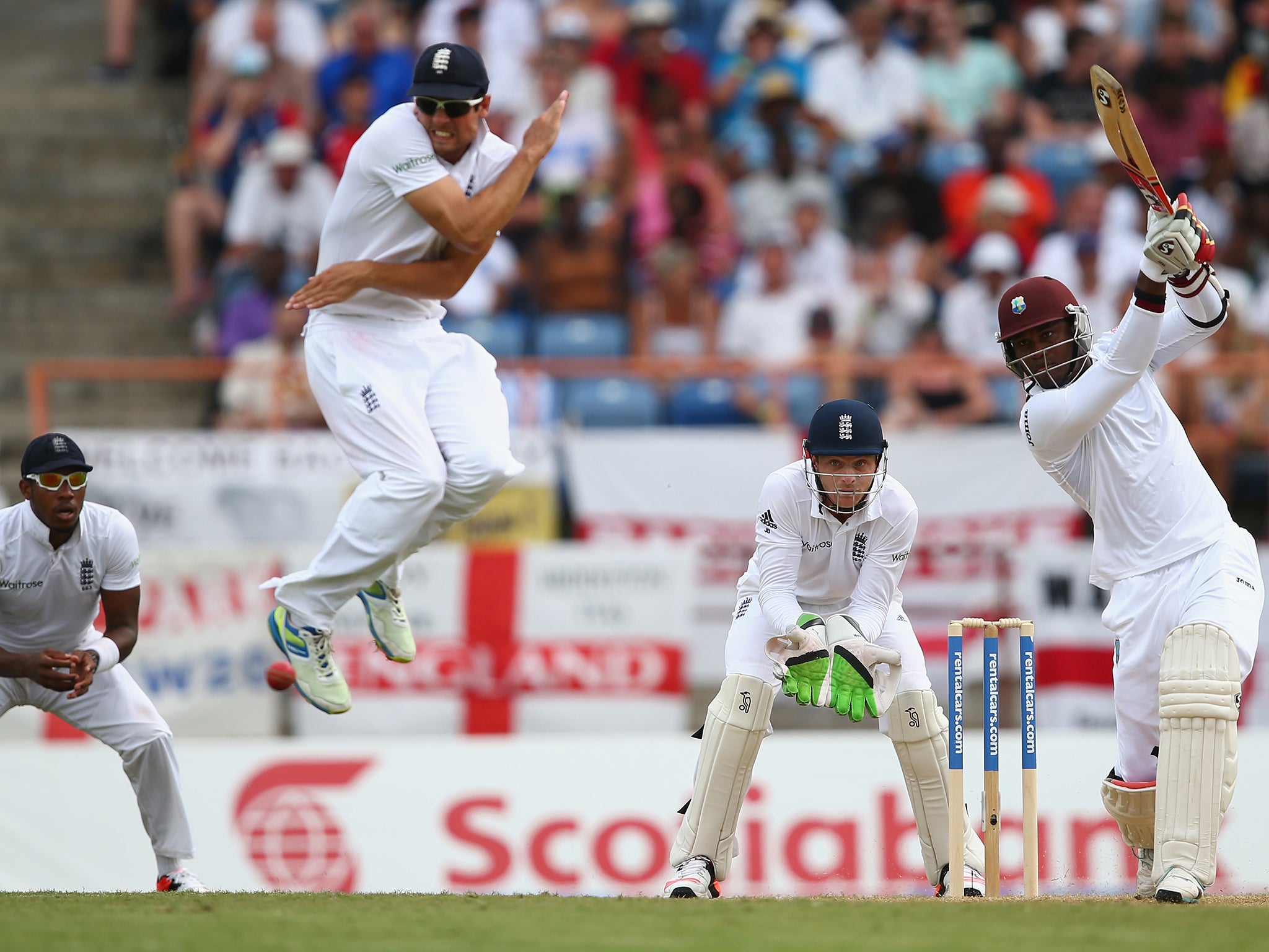 Alastair Cook of England leaps to avoid a cover drive from Marlon Samuels
