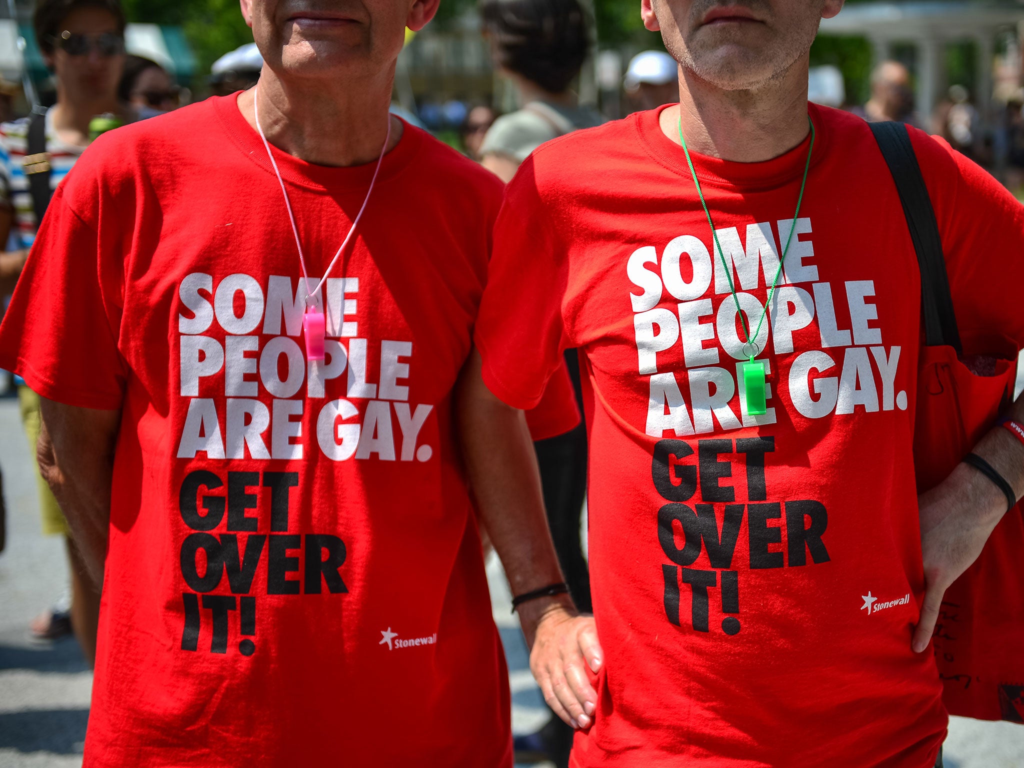 Two men wear tee shirts reading 'Some people are gay. Get over it!' during the Gay Pride Parade in Ljubljana, Slovenia, on June 15, 2013.